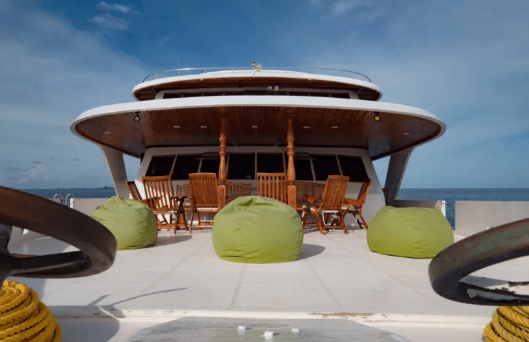 Open deck aboard Moonima with beanbags and wooden chairs